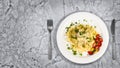 Fresh handmade tagliatelle pasta with forest mushrooms, parsley and cherry tomatoes salad Royalty Free Stock Photo