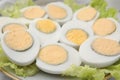 Fresh hard boiled eggs and lettuce on plate, closeup