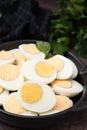 Fresh hard boiled eggs and parsley on brown table