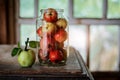 Fresh harvest of ripe and healthy farm apples in a glass jar, in a basket