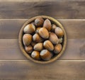 Fresh hazelnuts isolated on wooden background. Hazelnuts in a bowl with copy space for text. Royalty Free Stock Photo