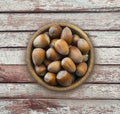 Fresh hazelnuts isolated on wooden background. Hazelnuts in a bowl with copy space for text. Hazelnut close-up on rustic table. Royalty Free Stock Photo