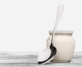 Healthy fresh yogurt with spoon on background Royalty Free Stock Photo