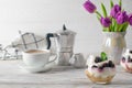 Fresh and healthy breakfast with granola, yogurt, coffee and purple tulips bouquet Royalty Free Stock Photo