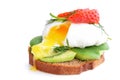 Fresh Healthy Breakfast:Poached egg on piece of rye bread with Avocado slices,Spinach and Strawberry .