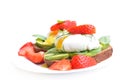 Fresh Healthy Breakfast:Poached egg on piece of rye bread with Avocado slices,Spinach and Strawberry .