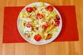 Fresh healthy caesar salad with chicken breast, cherry tomatoes, lettuce, parmesan cheese, dressing and croutons on wooden table. Royalty Free Stock Photo