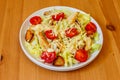 Fresh healthy caesar salad with chicken breast, cherry tomatoes, lettuce, parmesan cheese, dressing and croutons on wooden table Royalty Free Stock Photo