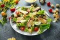 Fresh healthy Caesar salad with chicken, egg quail, tomatoes, Cheese and Croutons in a white plate Royalty Free Stock Photo