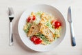 Fresh healthy caesar salad with chicken on white wooden table with fork and knife. Top view. Selective focus Royalty Free Stock Photo