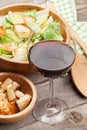Fresh healthy caesar salad and red wine Royalty Free Stock Photo