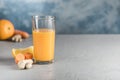 Fresh and healthy drink with orange, carrot and ginger on a light blue background Royalty Free Stock Photo