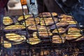 Fresh healthy eggplant or aubergine preparing on a barbecue grill over charcoal. Grilled aubergines eggplants slices. Vegetarian,