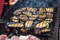Fresh healthy eggplant or aubergine preparing on a barbecue grill over charcoal. Grilled aubergines eggplants slices. Vegetarian,
