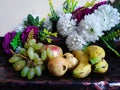 Fresh and Healthy fruit with artificial flower in background Royalty Free Stock Photo