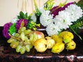 Fresh and Healthy fruit with artificial flower in background Royalty Free Stock Photo