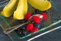 Fresh healthy fruit on a glass dessert plate on black background. Healthy eating concept Royalty Free Stock Photo