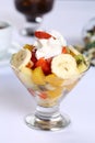 Fresh healthy fruit salad in a glass with whipping cream Royalty Free Stock Photo