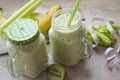 Fresh healthy green blended smoothie in glass mason jar. With bananas, kiwi, celery. Concept of diet or detox cocktail