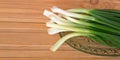 Fresh healthy onion queues on wood background