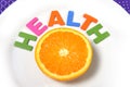 Fresh healthy Orange Fruit and health word on plate Royalty Free Stock Photo