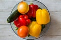 Fresh healthy organic produce. Fresh vegetables in a clear bowl on a white wooden table. Food background Royalty Free Stock Photo