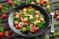 Fresh Healthy Prawns salad with tomatoes, red onion on black plate. concept healthy food Royalty Free Stock Photo