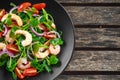 Fresh Healthy Prawns salad with tomatoes, red onion on black plate. concept healthy food Royalty Free Stock Photo