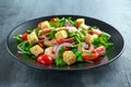 Fresh Healthy Prawns salad with tomatoes, red onion on black plate. concept healthy food Royalty Free Stock Photo