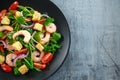 Fresh Healthy Prawns salad with tomatoes, red onion on black plate. concept healthy food Royalty Free Stock Photo