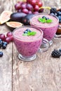 Fresh healthy pulpy cocktail with purple fruits and berries Royalty Free Stock Photo