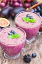 Fresh healthy pulpy cocktail with purple fruits and berries Royalty Free Stock Photo