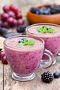 Fresh healthy pulpy cocktail with purple fruits and berries Royalty Free Stock Photo