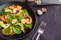 Fresh, healthy salad with shrimps, spinach and avocado on a black background. Top view. Royalty Free Stock Photo