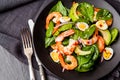 Fresh, healthy salad with shrimps, spinach and avocado on a black background. Top view. Royalty Free Stock Photo