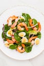 Fresh, healthy salad with shrimps, spinach and avocado on a marble table Royalty Free Stock Photo