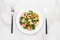 Fresh, healthy salad with shrimps, spinach and avocado on a marble table Royalty Free Stock Photo