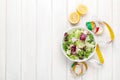 Fresh healthy salad, utensils and tape measure over white wooden Royalty Free Stock Photo