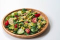 Fresh and healthy summer salad with cucumbers, tomatoes, avocado, arugula, sunflower seeds, lemons and chili flakes. Royalty Free Stock Photo