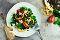 Fresh healthy vegetable salad with black lentil, cheese, yellow bulgarian pepper, arugula and pine nuts on white ceramic plate and Royalty Free Stock Photo