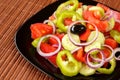 Fresh and healthy vegetable salad with green pepper and red onion rings, tomatoes and cucumber slices Royalty Free Stock Photo