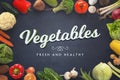 Fresh and healthy vegetables text on dark surface surrounded with vegetables