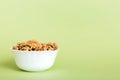 Fresh healthy walnuts in bowl on colored table background. Top view Healthy eating bertholletia concept. Super foods Royalty Free Stock Photo