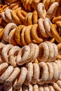 Fresh heap bagels on table. Bundle of bagels are sold at the fair-sale