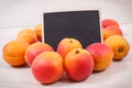 Fresh heap of peach. Healthy dessert as source minerals and vitamins. Place for text on black board Royalty Free Stock Photo