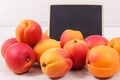 Fresh heap of peach. Healthy dessert as source minerals and vitamins. Place for text on black board Royalty Free Stock Photo