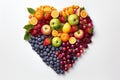 Fresh heart shaped fruit and vegetable assortment isolated on white, top view, vibrant and colorful Royalty Free Stock Photo