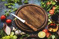 Fresh helthy food cooking vegetable ingredients on dark background with rustic wooden board. Diet or vegetarian food concept. Top