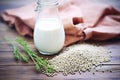 fresh hemp seeds spilling from a bag with hemp milk