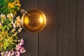 Fresh herbal tea made with linden, chamomile, clover and hypericum, in transparent glass cup with flowers and leaves around it on Royalty Free Stock Photo